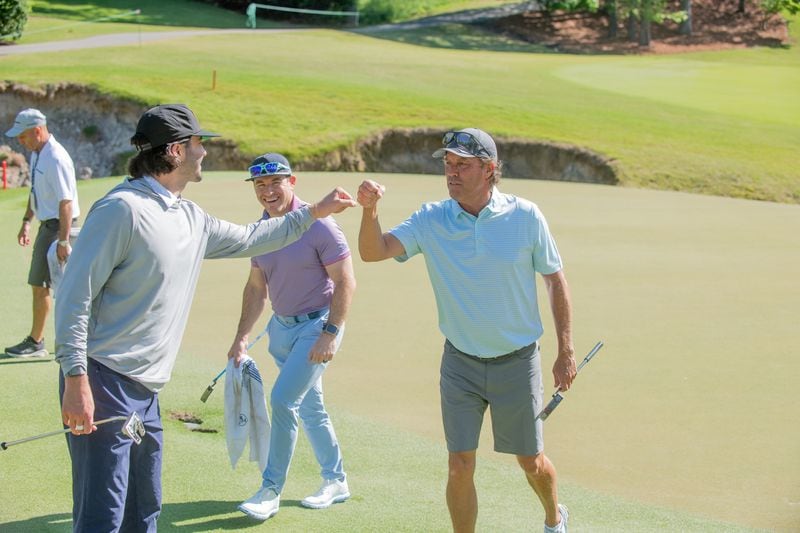 Two-time Mitsubishi Electric Classic champion Stephen Ames gives a fist bump to his pro-am partner on Thursday at TPC Sugarloaf, April 25, 2024. Ames won last year's tournament by four shots.