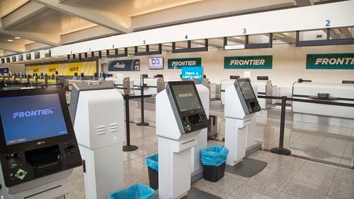 The Frontier Airlines self check-in kiosks were empty on Tuesday April 14, 2020 as the ticket counter was temporarily closed inside the domestic terminal at Hartsfield-Jackson International Airport in Atlanta. After scaling back flights early in the pandemic, the airline is expanding routes from Atlanta, including international flights. (ALYSSA POINTER / ALYSSA.POINTER@AJC.COM)