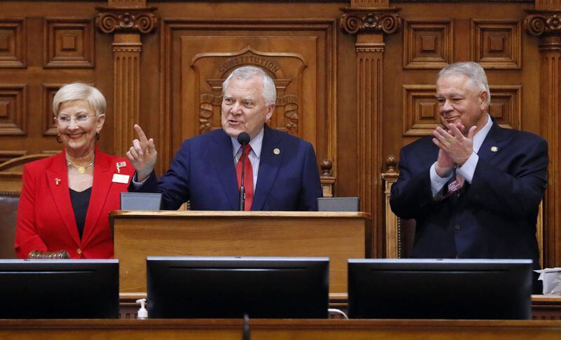 Gov. Nathan Deal, standing with Speaker David Ralston and first lady Sandra Deal, addresses the House for his last Sine Die. BOB ANDRES /BANDRES@AJC.COM