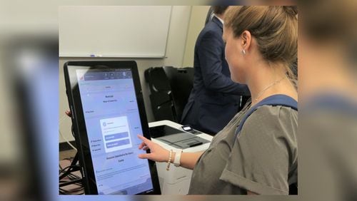 Georgia's new voting machines by Dominion Voting Systems were demonstrated at the Secretary of State's Office on Tuesday, Aug. 6, 2019. Voters will make their choices on touchscreens, which are connected to computers that will print out paper ballots for tabulation. Photo credit: Georgia Secretary of State