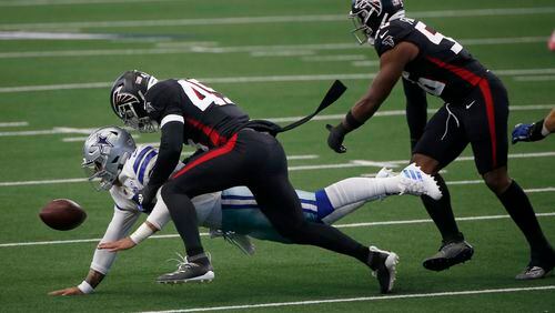 Cowboys quarterback Dak Prescott (4) fumbles the ball after being sacked by Falcons linebacker Deion Jones (45) with help from defensive end Dante Fowler (56) in the first half Sunday, Sept. 20, 2020, in Arlington, Texas. (Ron Jenkins/AP)