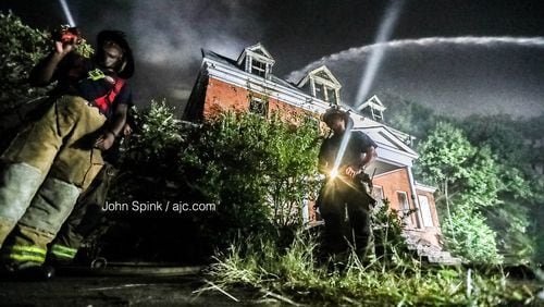 Atlanta firefighters continued to put out hot spots on the scene of a large fire near Morris Brown College on Thursday morning. Flames could be seen for miles as the fire raged Wednesday night.