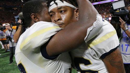 Georgia Tech quarterback TaQuon Marshall (right) gets a reassuring hug from cornerback Lance Austin after falling to Tennessee in double overtime. (Curtis Compton/ccompton@ajc.com)
