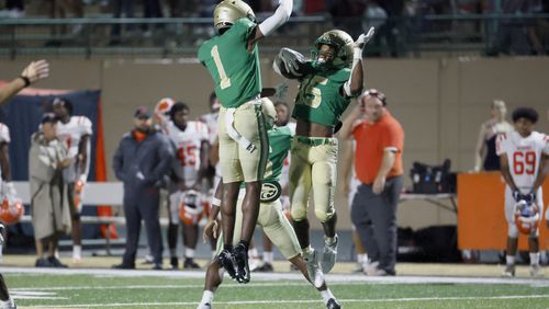 090222 Buford, Ga.: Buford defensive back Jordan Allen (15, right) celebrates his interception with defensive back K.J. Bolden (1) after Allen intercepted North Cobb quarterback Malachi Singleton (not pictured) to seal the win for Buford in the fourth quarter at Tom Riden Stadium, Friday, September 2, 2022, in Buford, Ga. Buford won 21-14. (Jason Getz / Jason.Getz@ajc.com)