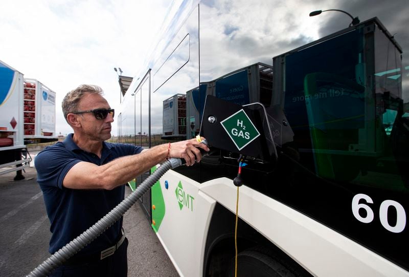A driver fills the tank of an urban bus with green hydrogen at a bus depot in Palma de Mallorca. The Georgia Department of Transportation is seeking input on how a network of hydrogen fueling stations might be created to serve commercial vehicles in the state. (Jaime Reina/AFP/Getty Images/TNS)