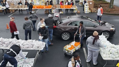 Employees from the Transportation Security Administration and Customs and Border Protection and their families waited in line for about an hour for groceries from the Atlanta Community Food Bank and Antioch Baptist Church. Bob Andres / bandres@ajc.com