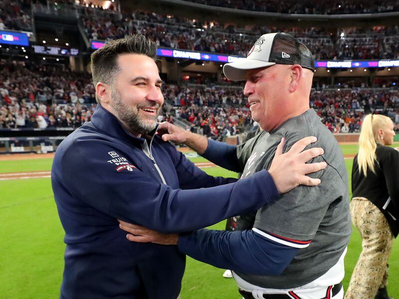 10/23/21 - Atlanta - Atlanta Braves general manager Alex Anthopoulos, left, and manager Brian Snitker celebrate the BravesÕ 4-2 win against the Los Angeles Dodgers to advance to the World Series in game 6 at the National League Championship Series at Truist Park, Saturday October 23, 2021, in Atlanta. Curtis Compton / curtis.compton@ajc.com 