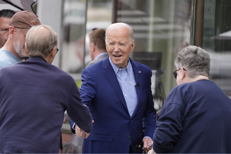 President Joe Biden greets visitors as he visits the War Memorial in Scranton, Pa., Wednesday, April 17, 2024. Biden's uncle, Ambrose J Finnegan Jr., who died in WWII, is listed on the wall. (AP Photo/Alex Brandon)