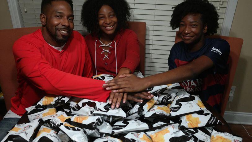 Dondre Anderson (left) and his two daughters, Amari (center) and Amina (right), are owners of one of the world’s few black-owned potato chip companies. CONTRIBUTED BY DONDRE ANDERSON