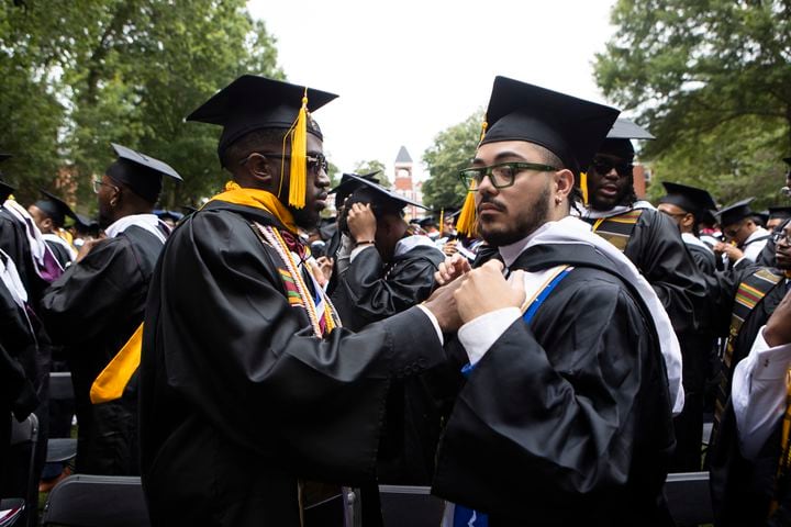 Members of the Morehouse College class of 2023 bestow stolls upon their peers during the Morehouse College commencement ceremony on Sunday, May 21, 2023, on Century Campus in Atlanta. The graduation marked Morehouse College's 139th commencement program. CHRISTINA MATACOTTA FOR THE ATLANTA JOURNAL-CONSTITUTION