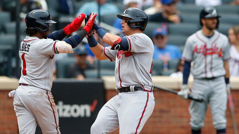 Braves infielders Ozzie Albies and Austin Riley celebrate after scoring against the New York Mets during the fourth inning Thursday, July 29, 2021, in New York. The Braves won 6-3. (Noah K. Murray/AP)
