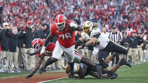 Georgia defensive lineman Nazir Stackhouse (78) is tackled by the sideline after he returned an interception from Missouri quarterback Brady Cook (not pictured) during the fourth quarter at Sanford Stadium, Saturday, November 4, 2023, in Athens, Ga. Georgia won 30-21. (Jason Getz / Jason.Getz@ajc.com)