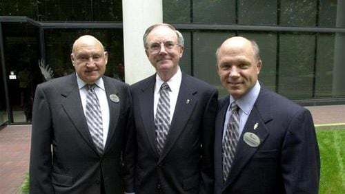 Chick-fil-A execs pose for a photo before entering their Atlanta headquarters to attend a function for outgoing president Jimmy Collins (center) in 2001. S. Truett Cathy (left) opened the Dwarf Grill (later the Dwarf House) in 1946 in Hapeville. The first Chick-fil-A was opened in 1967 at the Greenbriar Mall in South Atlanta. Truett's son Dan Cathy (right) continues the family tradition as company president.