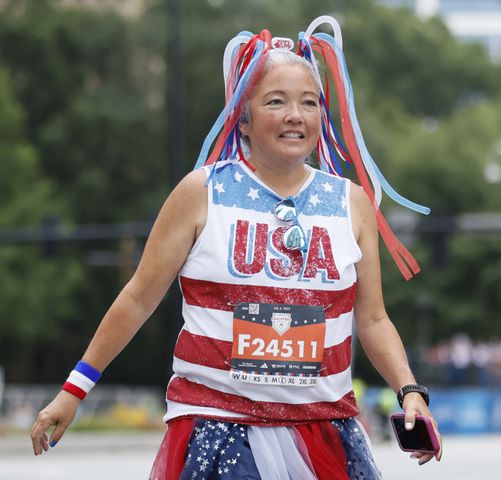 Costumed runners on Peachtree Street during the 54th running of The Atlanta Journal-Constitution Peachtree Road Race on Tuesday, July 4th, 2023.   (Miguel Martinez / Miguel.Martinezjimenez@ajc.com)