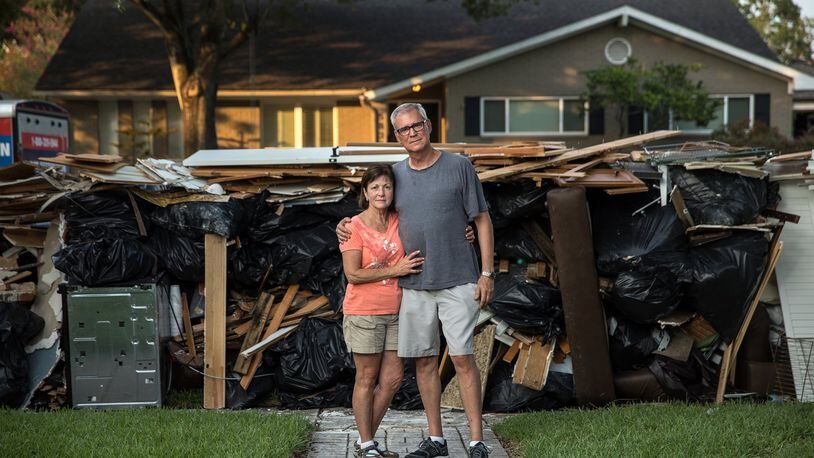 John Walton, 68, and Michele Walton, 61, outside of their flood-damaged home in Houston. Amid the storm devastation, some people in Texas found ways to save treasured personal items. (Tamir Kalifa/The New York Times)