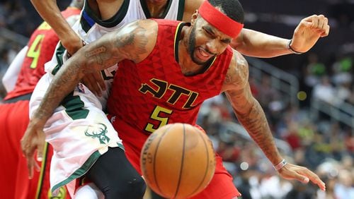 Hawks’ Malcolm Delaney battles to get the turnover from Bucks Giannis Antetokounmpo in a NBA basketball game on Sunday, Jan. 15, 2017, in Atlanta. Curtis Compton/ccompton@ajc.com