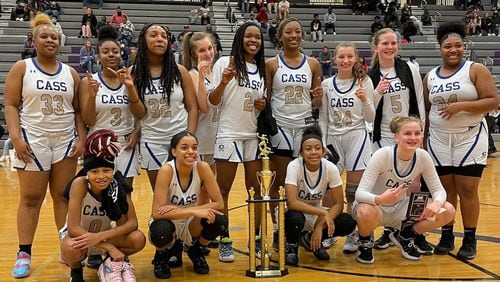 The Cass girls pose with their trophy after winning the SMI Carrollton Christmas Tournament.