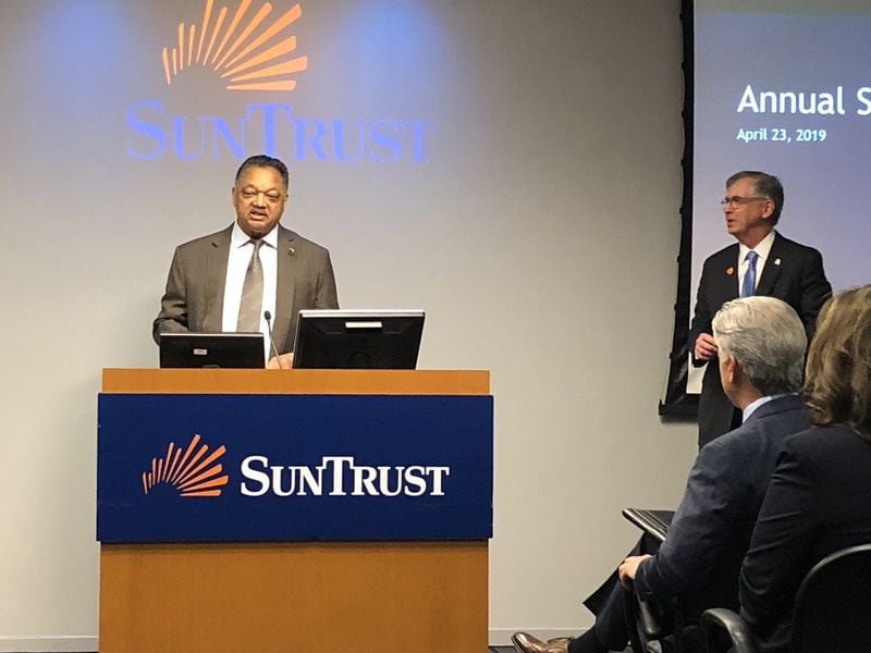 The Rev. Jesse Jackson, left, speaks during the SunTrust Banks annual meeting on Tuesday, April 23, 2019, in downtown Atlanta as SunTrust Chairman and CEO Bill Rogers looks on. J. SCOTT TRUBEY/STRUBEY@AJC.COM