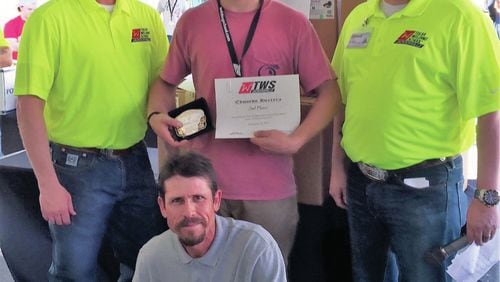Cherokee High School senior Ed Herrera, who is pictured with his father, front row, and Tulsa Welding School representatives. He placed second in the national competition and earned a $9,000 scholarship, welding equipment and tools and a champion buckle.