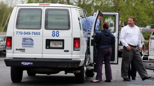 April 15, 2014 Douglasville: Rideshare vans were used to shuttle mourners to the visitation for Cpt. Herb Emory Tuesday afternoon April 15, 2014 in Douglasville. BEN GRAY / BGRAY@AJC.COM