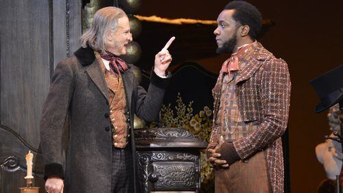 Continuing through Dec. 24, the Alliance Theatre’s “A Christmas Carol” co-stars David de Vries (as Ebenezer Scrooge) and Neal Ghant (as Bob Cratchit). CONTRIBUTED BY GREG MOONEY