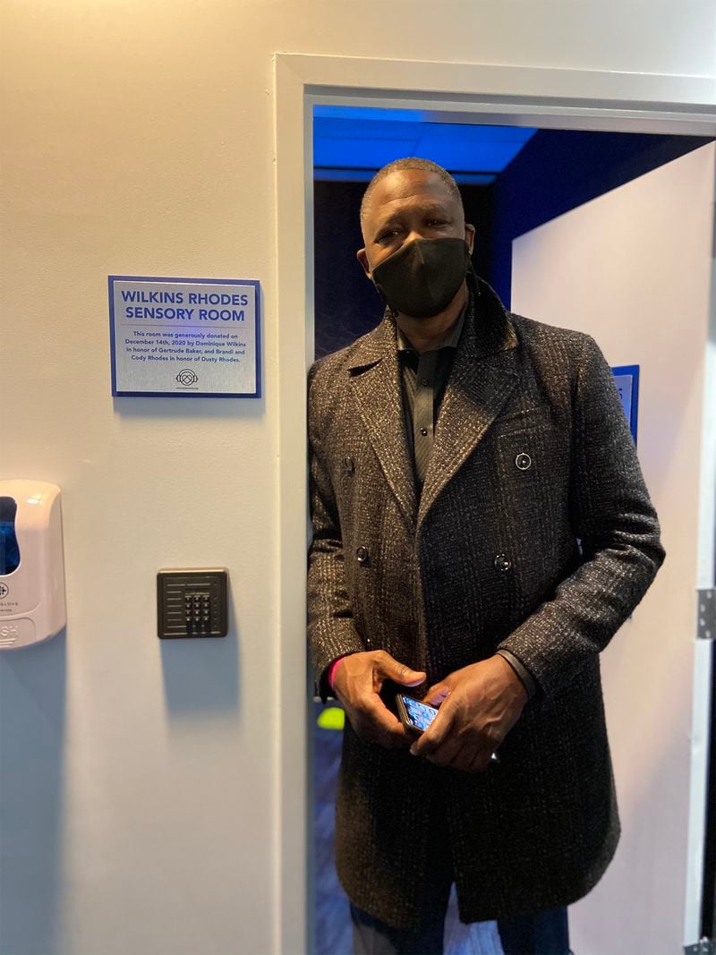 Basketball great Dominique Wilkins, chairman of KultureCity, stands in front of the Wilkins Rhodes Sensory Room at State Farm Arena. 
(Courtesy of KultureCity)
