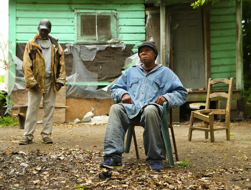 **** POSSIBLE VISUAL LEDE**** 032915 PELHAM: Poverty stricken Adel Edwards, 54, sits outside his home by a small pile of leaves with his friend Henry Smith, 62, who is often with him on Monday, March 30, 2015, in Pelham. Edwards was fined $500 by a judge for burning without a permit and was placed on 12 months of probation with a private probation company. Curtis Compton / ccompton@ajc.com