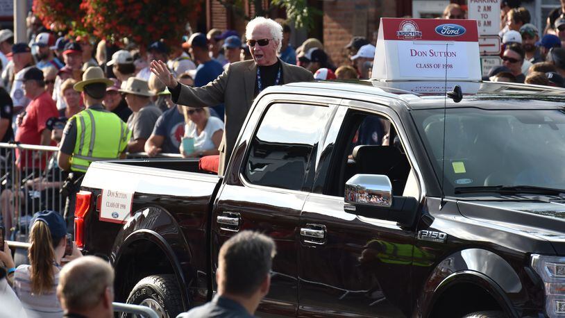 Don Sutton, a 1998 inductee into the Baseball Hall of Fame, waves to spectators from the back of a pickup truck during a "Legends Parade" in Cooperstown, N.Y., on July 28, 2018.