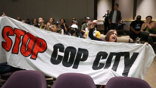 Protestors hold a banner and shout, "Stop Cop City," during the public comment portion of the Atlanta City Council ahead of the final vote to approve legislation to fund the training center at Atlanta City Hall, on Monday, June 5, 2023, in Atlanta. (Jason Getz/The Atlanta Journal-Constitution/TNS)