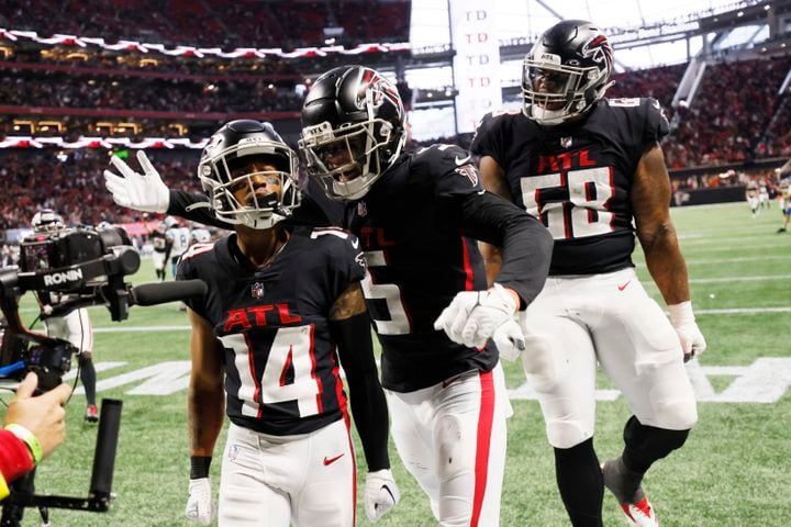 Falcons wide receiver Drake London (5) and offensive tackle Elijah Wilkinson (68) celebrate with receiver Damiere Byrd after Byrd scored in the fourth quarter Sunday against the Panthers. (Miguel Martinez / miguel.martinezjimenez@ajc.com)