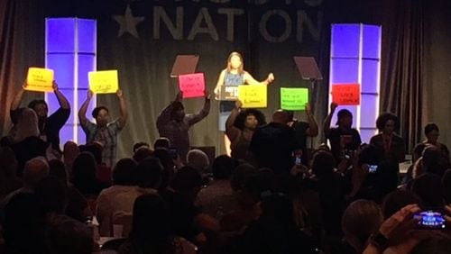 Democratic gubernatorial candidate Stacey Evans had a tough time Saturday, August 12th, at the Netroots Nation convention in Atlanta, as protesters shouted “Trust Black Women!” as she tried to speak. AJC Photo by Greg Bluestein