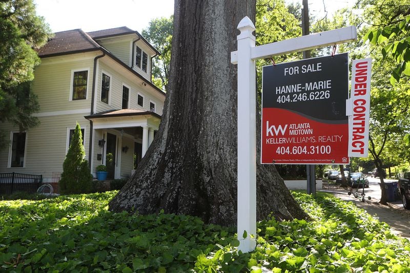 A for sale sign sits in the front yard of an Atlanta house under contract in late May. Curtis Compton/ccompton@ajc.com