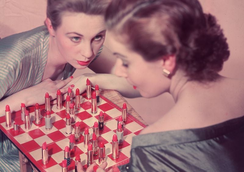 circa 1955:  Two women playing an unusual game of chess, with lipstick instead of chess pieces.  (Photo by Chaloner Woods/Getty Images)