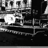 March, 17, 1954 -- The Coca-Cola float makes its way past the Paramount Theatre in downtown Atlanta as part of the city's annual St. Patrick's Day parade. LANE BROS. PHOTOGRAPHIC COLLECTION / GSU