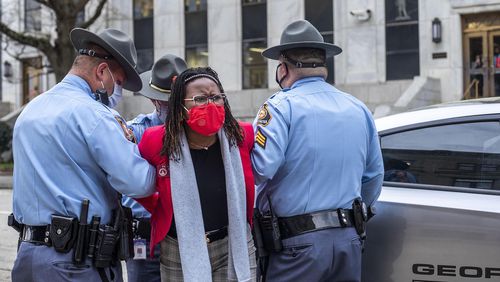 Rep. Park Cannon (D-Atlanta) is placed into the back of a Georgia State Capitol patrol car after being arrested by Georgia State Troopers on day 38 of the legislative session at the Georgia State Capitol Building in Atlanta, Thursday, March 25, 2021. (Alyssa Pointer/Atlanta Journal-Constitution/TNS)