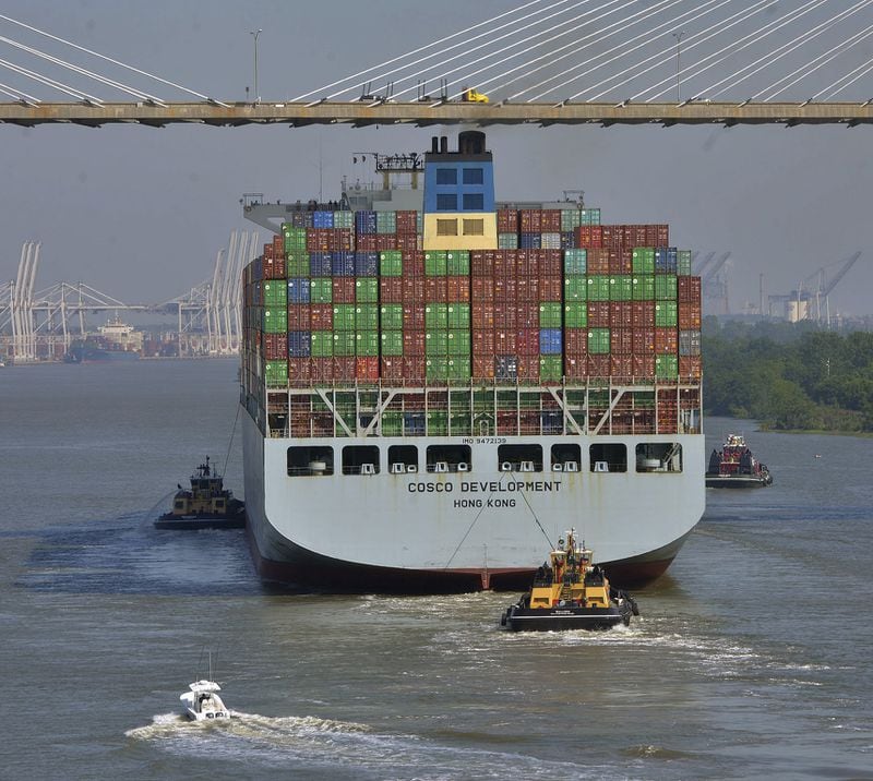 The container ship COSCO Development is guided under the Talmadge Memorial Bridge, Thursday morning, May 11, 2017, in Savannah, Ga, as the vessel sails up the Savannah River to the Port of Savannah. The ship is the largest vessel ever to call on the U.S. East Coast. (Steve Bisson/Savannah Morning News via AP)