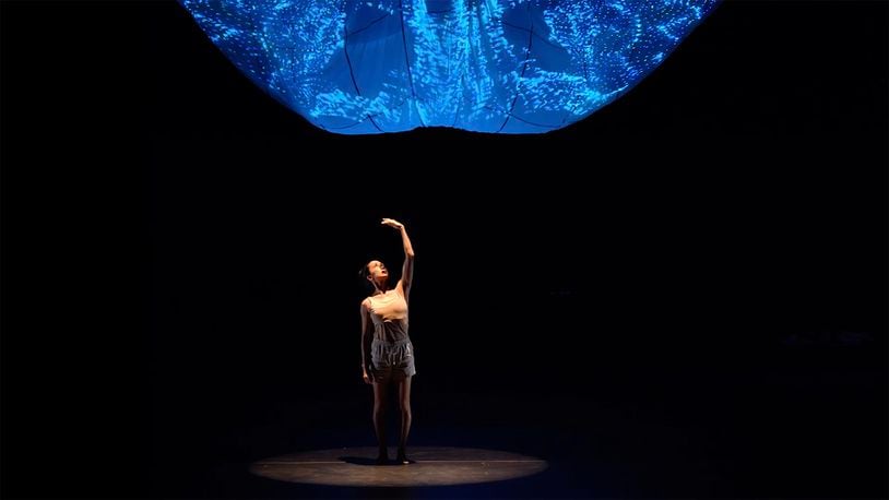 In "Step the Brain Along a Path," Terminus Modern Ballet Theatre's Rachel Van Buskirk moves beneath a glowing projection design based on brain imaging.
Courtesy of Felipe Barral