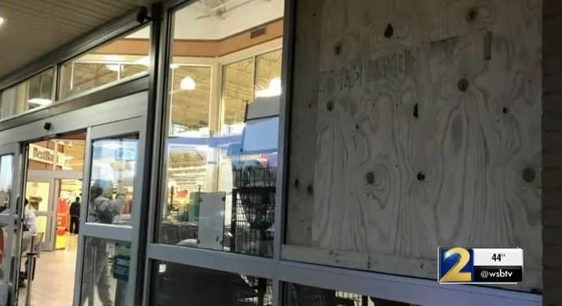 Plywood was placed on a window at the Old National Highway Kroger after shots were fired during a robbery. (Credit: Channel 2 Action News)