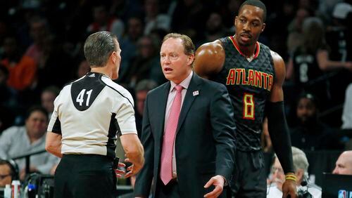 Atlanta Hawks coach Mike Budenholzer and Hawks center Dwight Howard react while talking with referee Ken Mauer during the second half against the Brooklyn Nets on Sunday, April 2, 2017, in New York. The Nets won 91-82. (AP Photo/Adam Hunger)