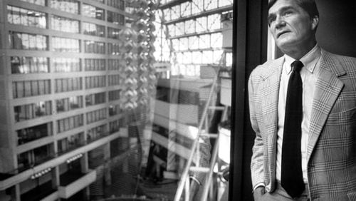 Tom Cousins, president of Cousins Properties, looks out onto the Omni atrium from his office in the north tower in 1983.
