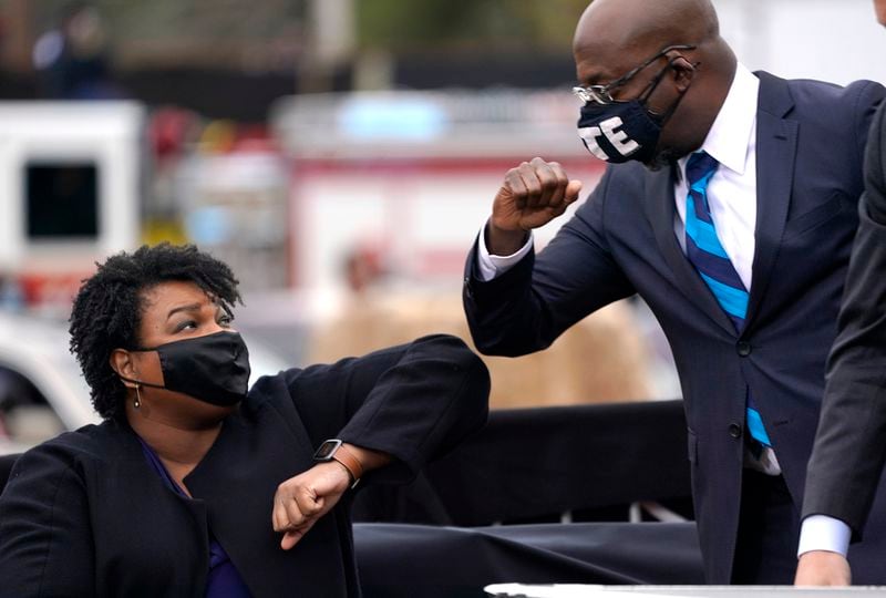 Democratic gubernatorial candidate Stacey Abrams and U.S. Sen. Raphael Warnock, shown bumping elbows last year at a Warnock campaign stop, will likely work together next year when each is running for office. (Drew Angerer/Getty Images/TNS)