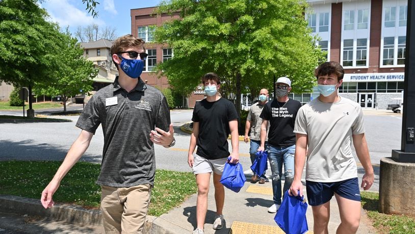 Tour guide John Hovell (left) leads potential students and a parent on a tour of the University of North Georgia's Dahlonega campus on Wednesday, April 28, 2021. (Hyosub Shin / Hyosub.Shin@ajc.com)