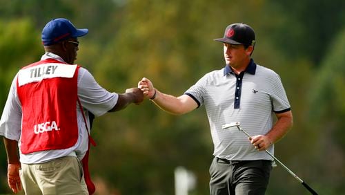 Bradford Tilley shares a fist bump with his caddie after he birdied the 15th hole during the second round of stroke play at the 2017 U.S. Mid-Amateur at Capital City Club in Atlanta, Ga. on Monday, Oct. 9, 2017. (Copyright USGA/Chris Keane)