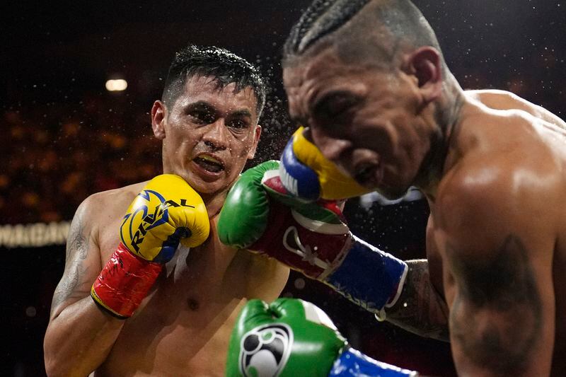 Fabian Maidana lands a left to Mario Barrios in a welterweight title fight Saturday, May 4, 2024, in Las Vegas. (AP Photo/John Locher)