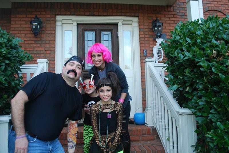 Emily Moore (pictured with pink hair) enjoys Halloween, her favorite holiday, with her husband, Kurt, and children, Jordan and Hallie. CONTRIBUTED