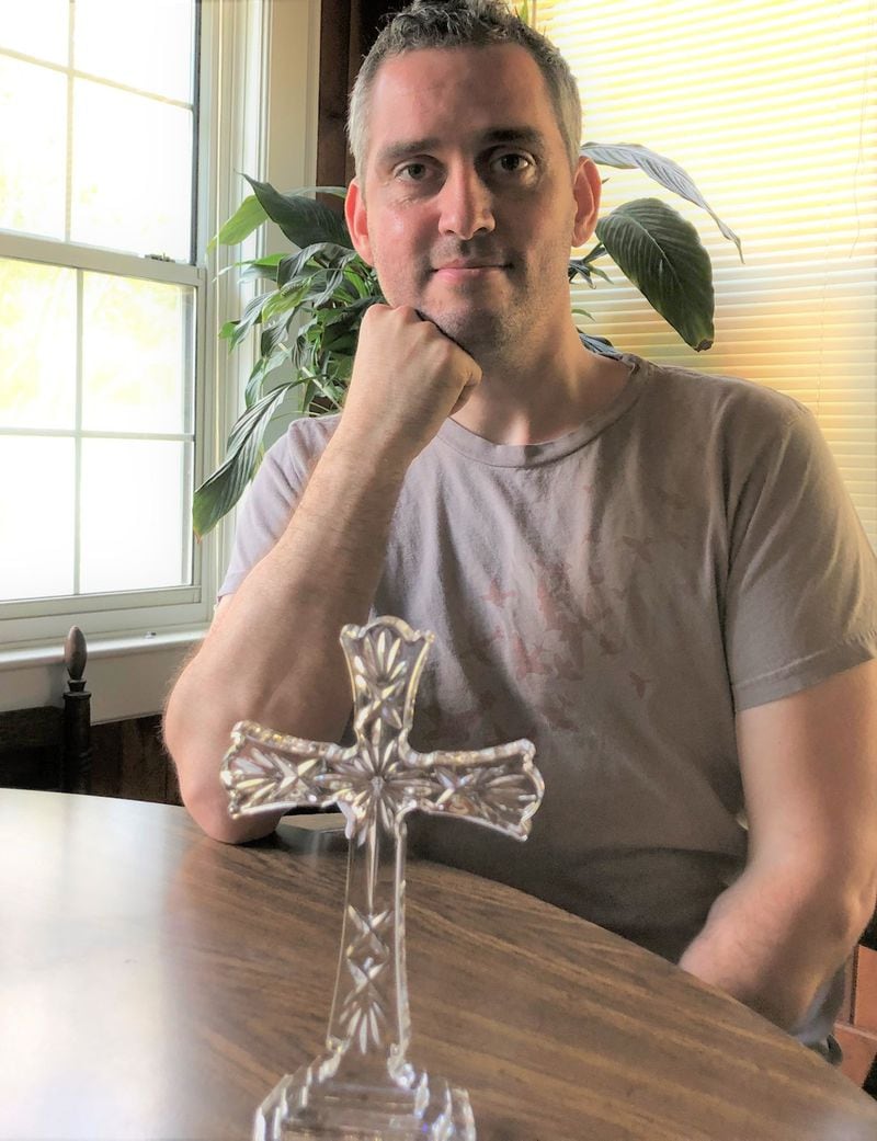 On his final day at Our Lady of the Mount Catholic Church, John Thomas McCecil says the church presented him with this cross. GRACIE BONDS STAPLES / GSTAPLES@AJC.COM