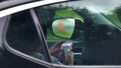 According to AAA, 75 percent of its Georgia members surveyed earlier this month reported seeing other drivers holding a phone regularly or fairly often. HYOSUB SHIN / HSHIN@AJC.COM