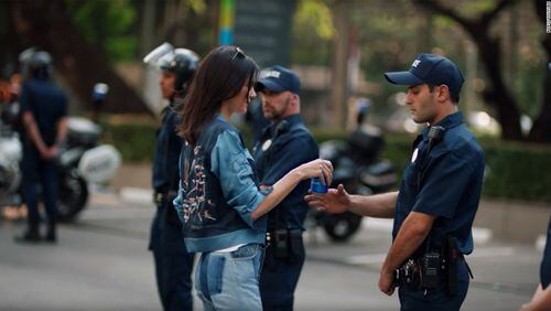 Portland anarchists used full Pepsi cans as weapons instead of peace offerings like Kendall Jenner. (Image from Pepsi's much derided ad.)