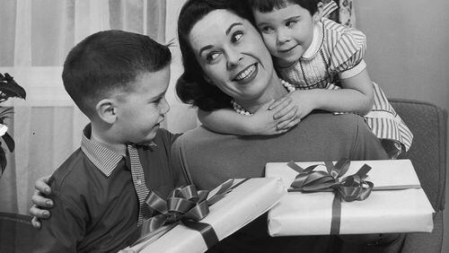 A boy and girl give presents to their mother on Mother's Day, circa 1955. (Photo by Lambert/Getty Images)