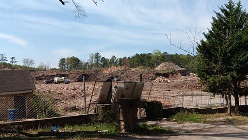 Contractors clean up a years-old illegal landfill at 7365 Bishop Road in South Fulton on March 21. The land sold in June 2023 and the new owner plans to use it as a storage site.